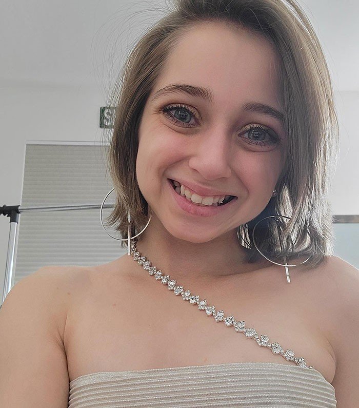Shauna Rae smiles in a glam selfie with hoop earrings