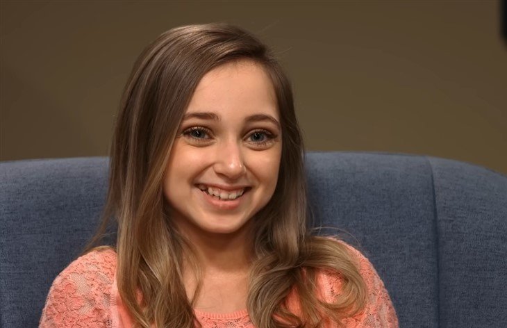 Shauna Rae sitting in an armchair in a scene from I Am Shauna Rae