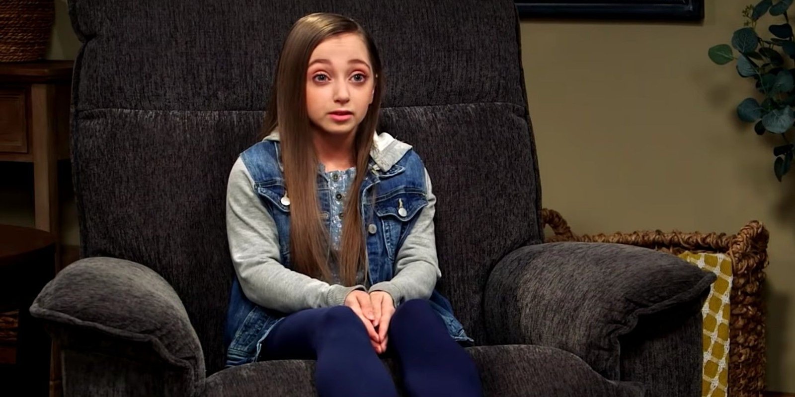 Shauna Rae sitting in an armchair in a scene from I Am Shauna Rae