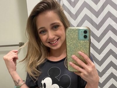 Shauna Rae takes a mirror selfie showing her arm tattoos