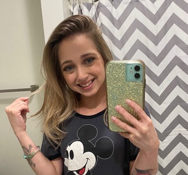 Shauna Rae takes a mirror selfie showing her arm tattoos