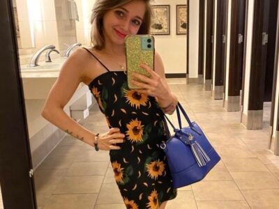 Shauna Rae takes a mirror selfie in a sunflower dress — the 27-year-old woman at the center of the independence debate
