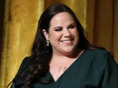 Whitney Way Thore smiling in a green dress