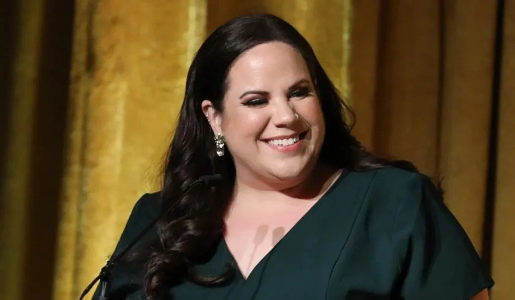 Whitney Way Thore smiling in a green dress
