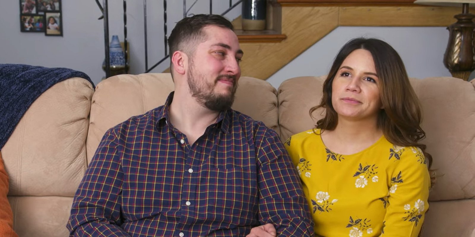 Jason and Justina from I Love a Mama's Boy sitting on a couch
