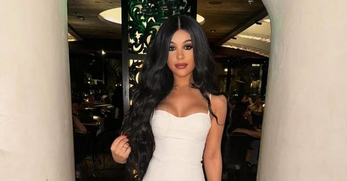 Emma Perry in a white dress