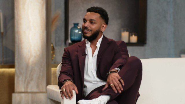Jamal Menzies in a burgundy suit