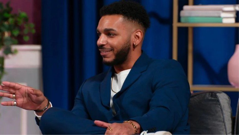 Jamal Menzies in a blue suit at the tell-all
