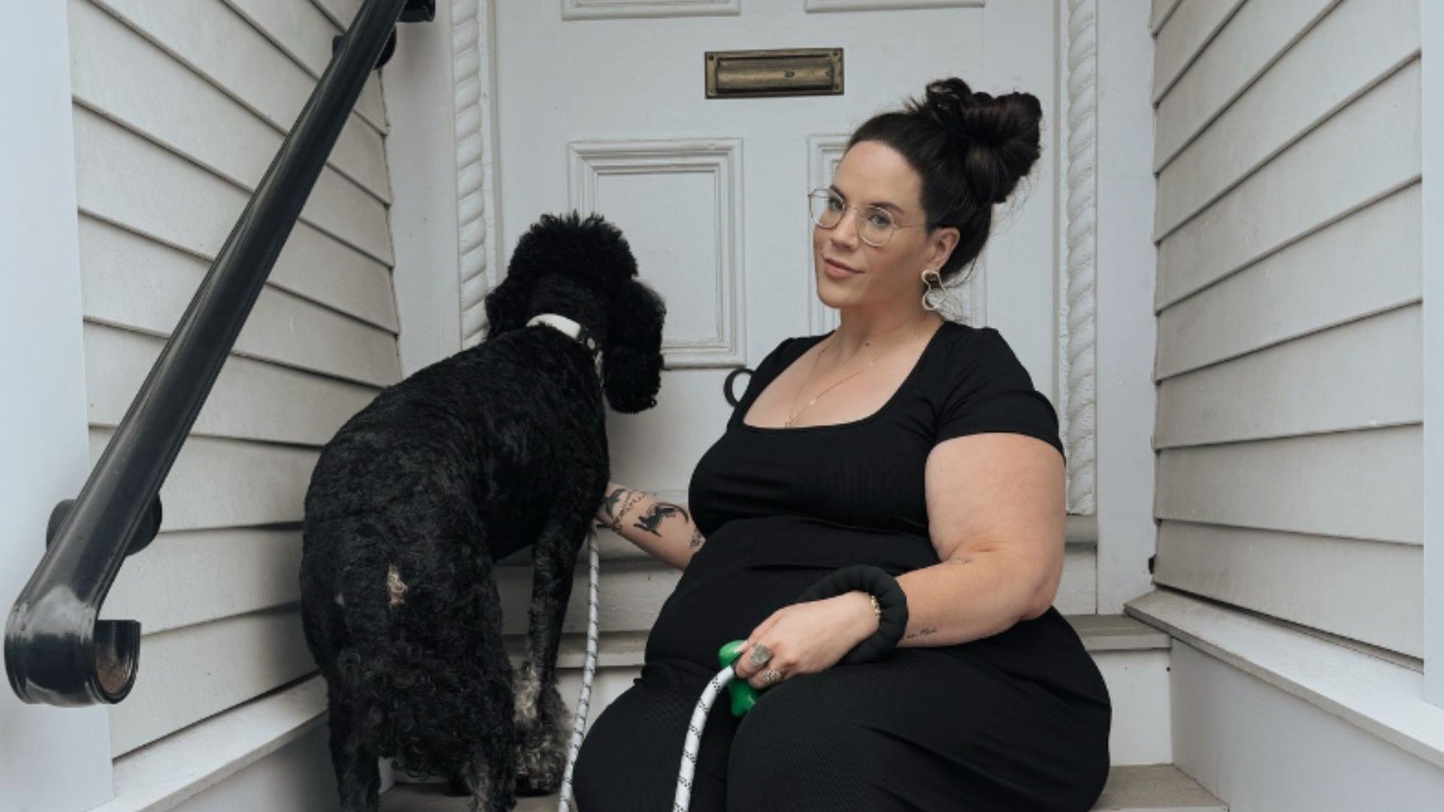 Whitney Way Thore sitting on her porch with her dog