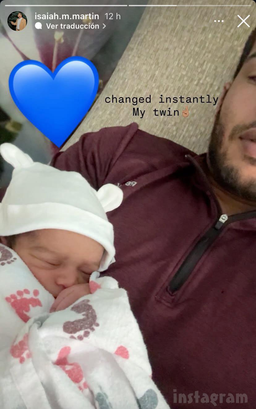 Isaiah Martin holding his newborn baby boy
