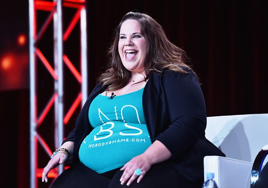 Whitney Way Thore laughing at a television panel