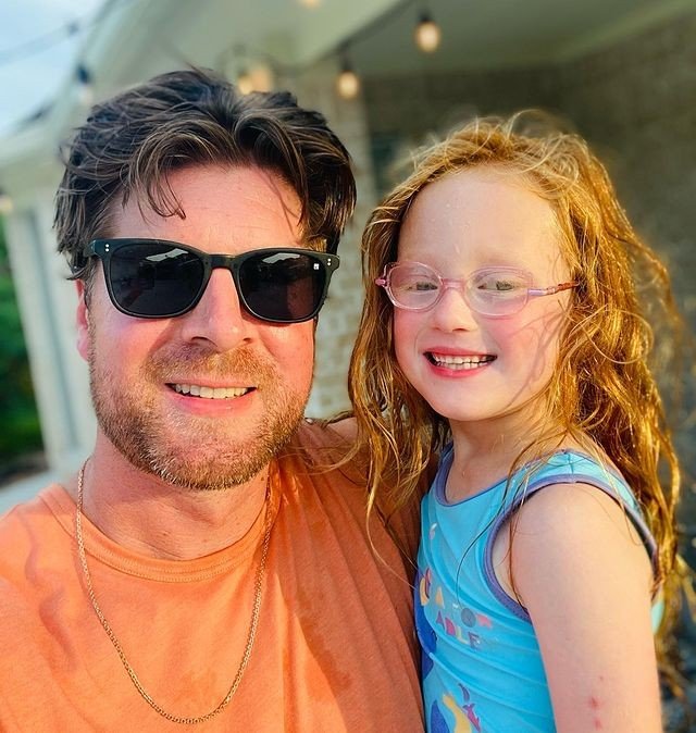 Uncle Dale Mills and Hazel Busby smiling in a sunny backyard selfie