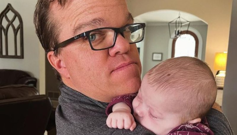Trent Johnston holding his granddaughter Leighton as she sleeps