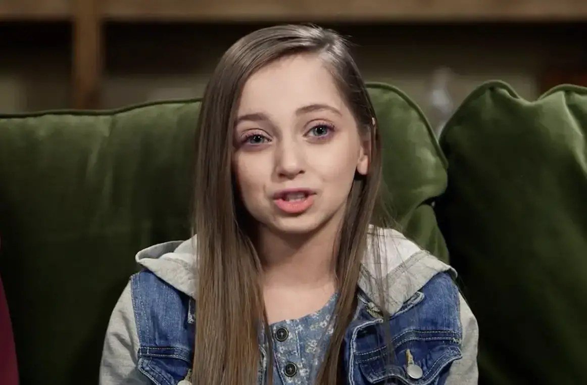 Shauna Rae sitting on a couch during I Am Shauna Rae
