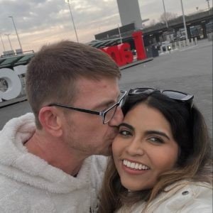 Jonathan kissing Ally on the cheek in a happy selfie