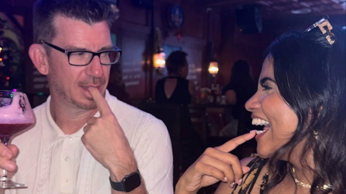 Ally and Jonathan laughing together at a bar