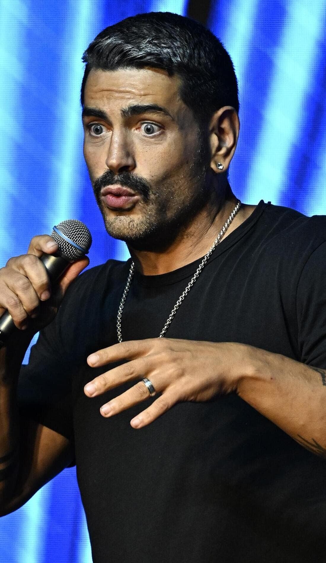 Sarper Guven performing on his comedy tour