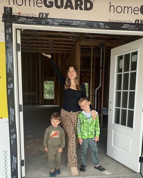 Jenna Ronan and her sons at the construction site of their new house