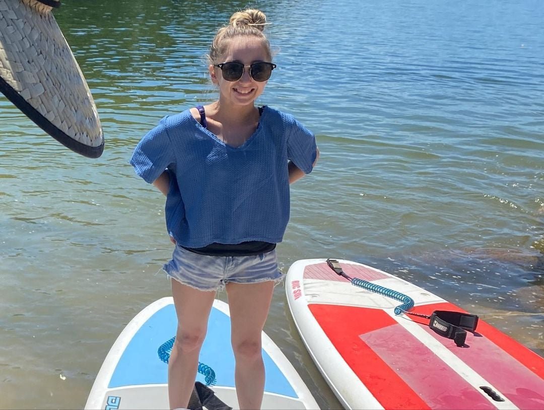 Shauna Rae paddleboarding on a lake