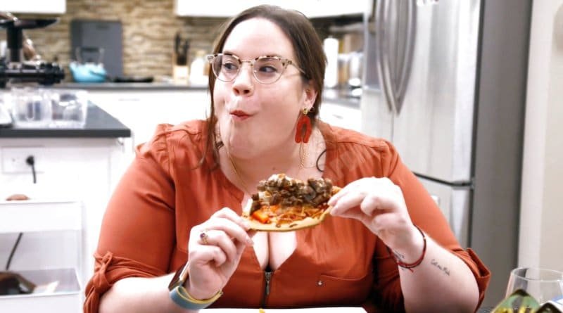 Whitney Thore eating in a kitchen scene from the show