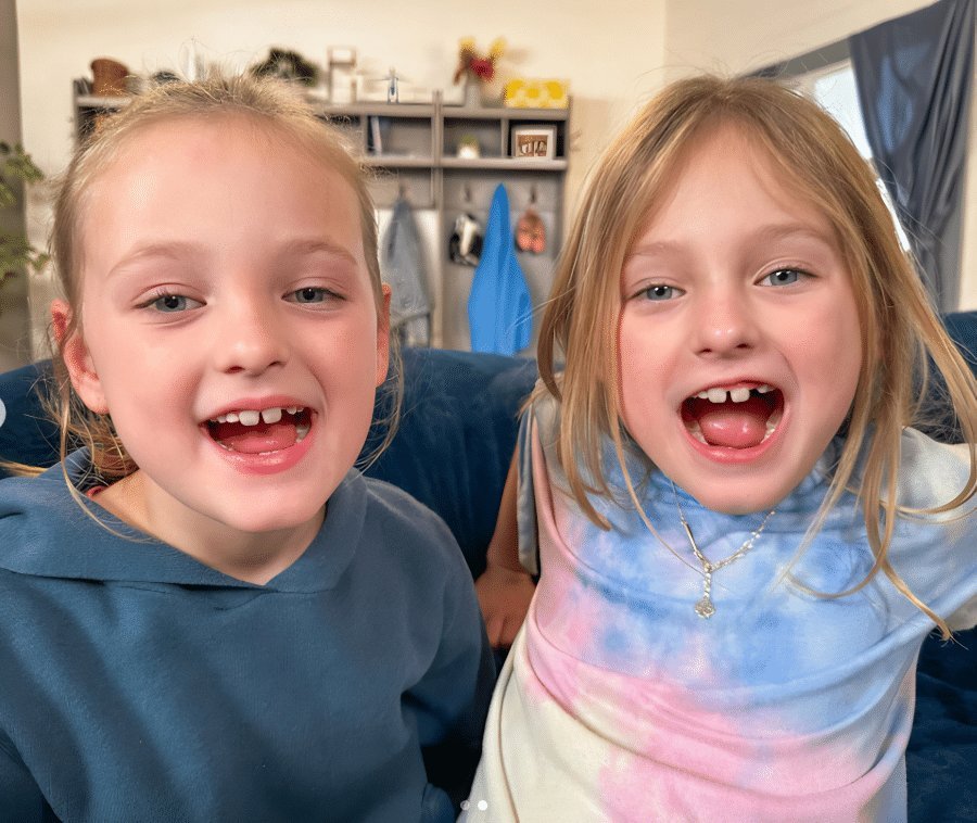 Ava and Olivia Busby smiling together, the OutDaughtered twins at the center of the Fanning sisters lookalike debate