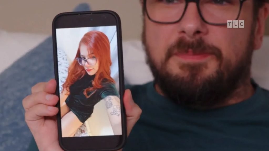 Colt Johnson holding a photo of Diana