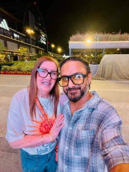 Jenny Slatten and Sumit Singh smiling on a night out