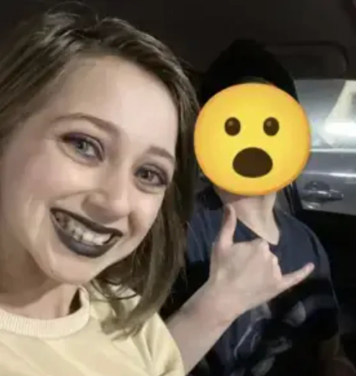 Shauna Rae smiling beside a man whose face is covered by an emoji