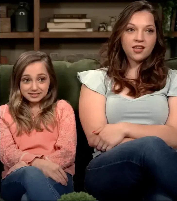 Shauna Rae sitting with her sister Tara on a couch
