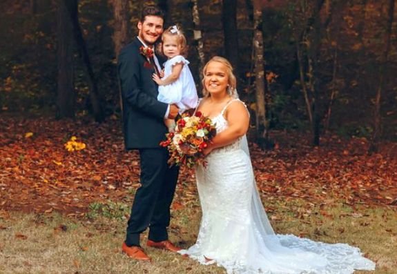 Elizabeth and Brice on their wedding day with baby Leighton