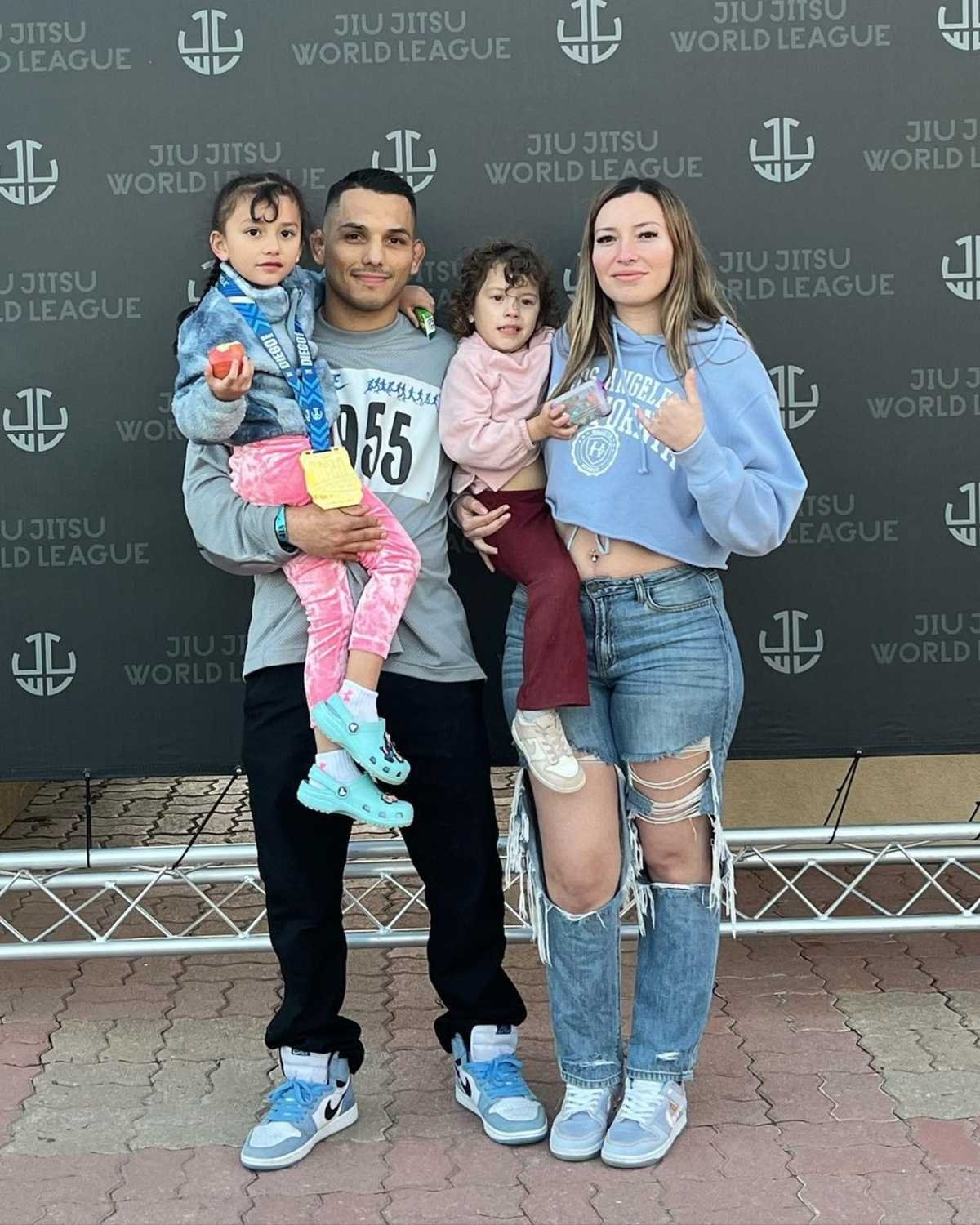 Roberto and Kristy with their two kids at a jiu-jitsu event