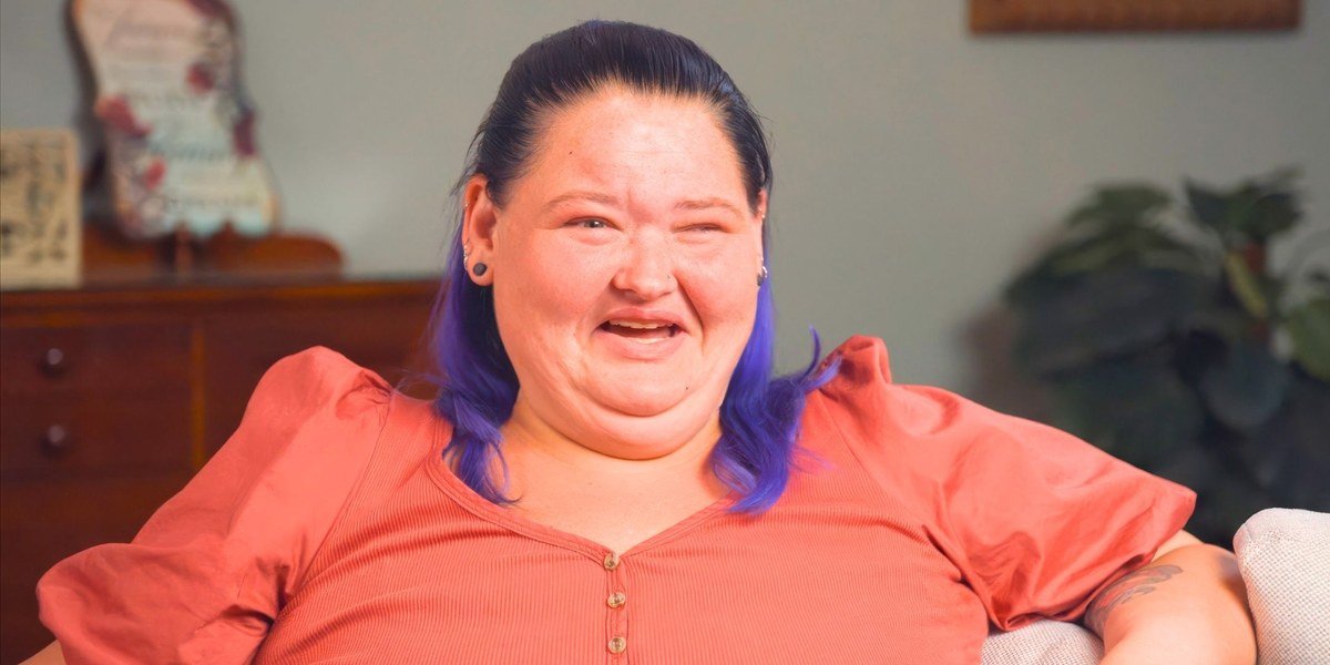 Amy Slaton smiling in a coral top