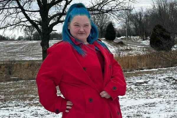 Amy Slaton standing outdoors in a red coat