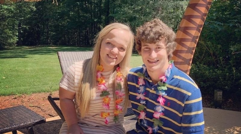 Throwback photo of Liz Johnston and Brice Bolden wearing flower leis outdoors