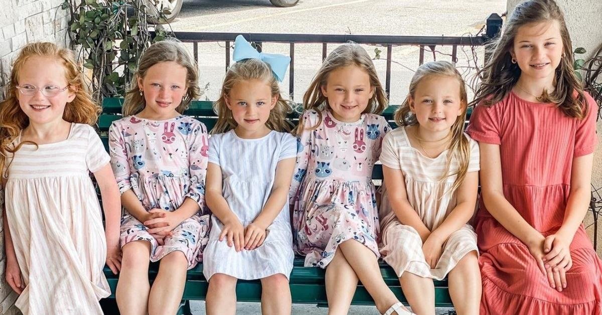 Blayke Busby and the quintuplets sitting on a bench
