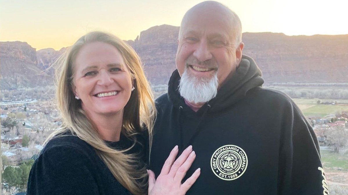 Christine Brown Woolley and David Woolley smiling together outdoors