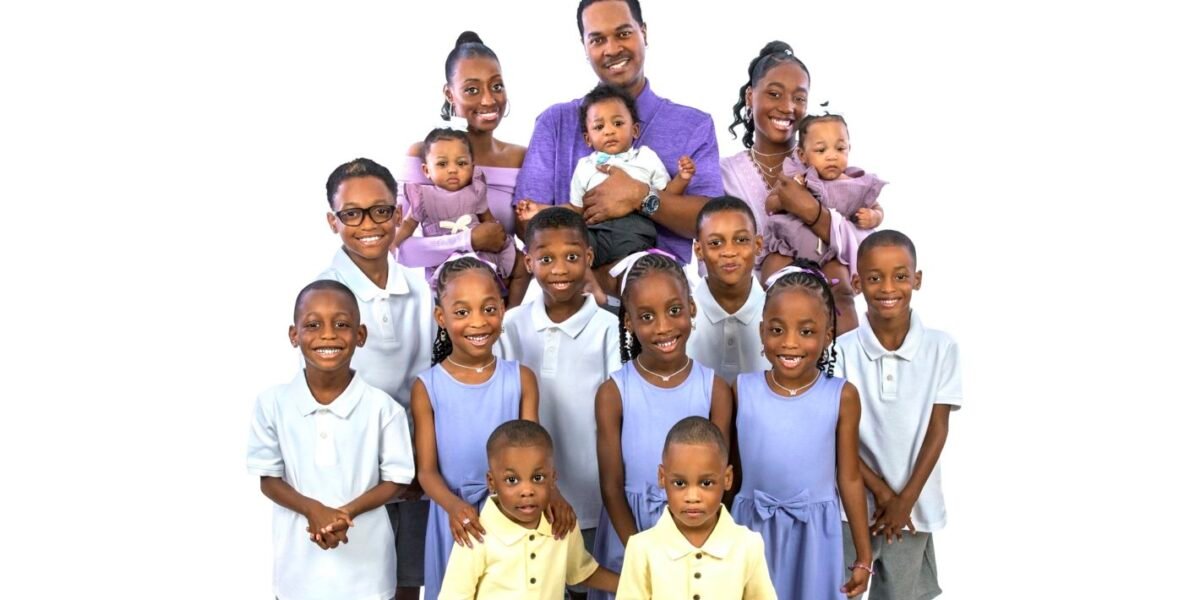 Deon and Karen Derrico posing with all 14 of their children