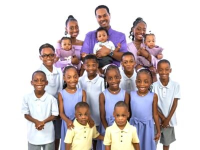 Deon and Karen Derrico posing with all 14 of their children