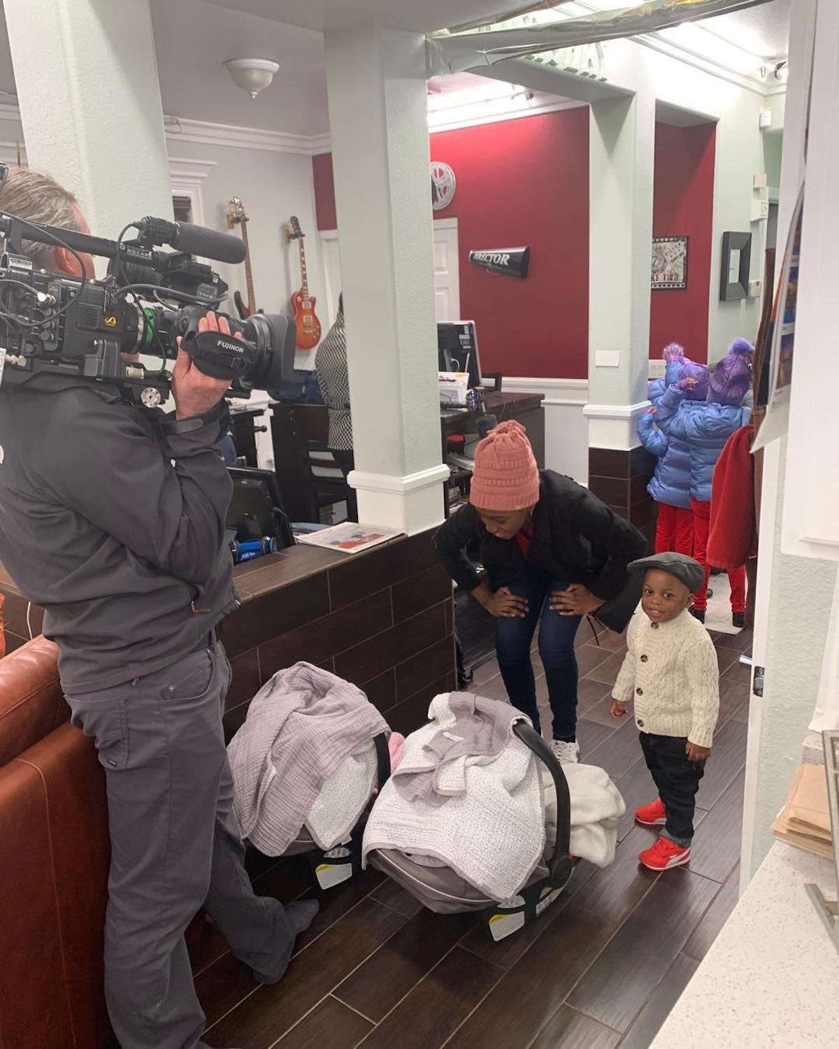 A TLC camera crew filming Karen Derrico and the kids at home