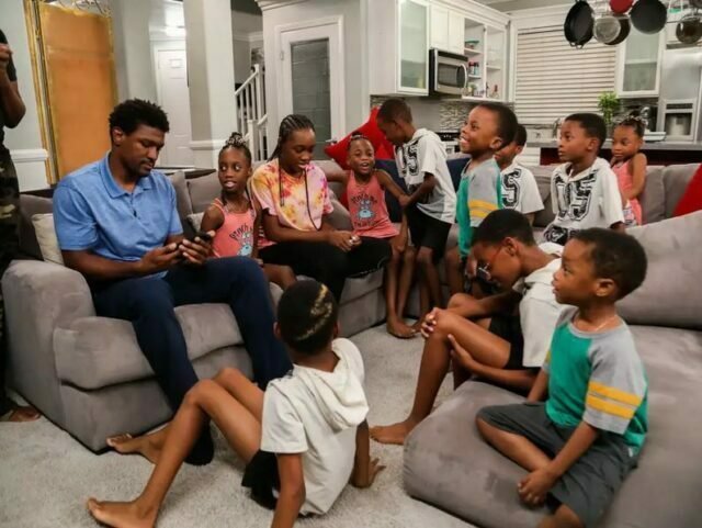 Deon Derrico on the living room couch surrounded by his kids