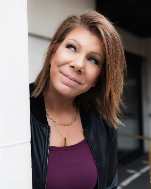 Meri Brown smiling, looking up