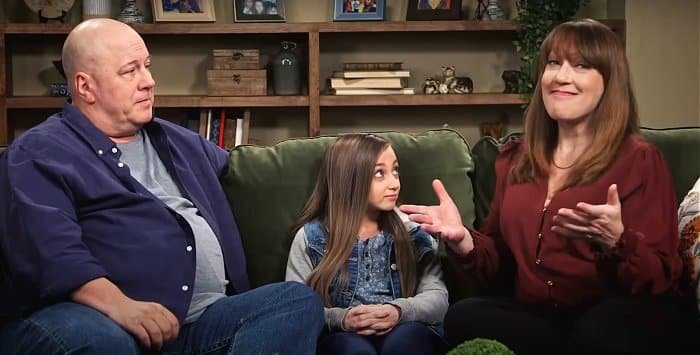 Shauna Rae on the couch with her mom Patty and stepdad Mark