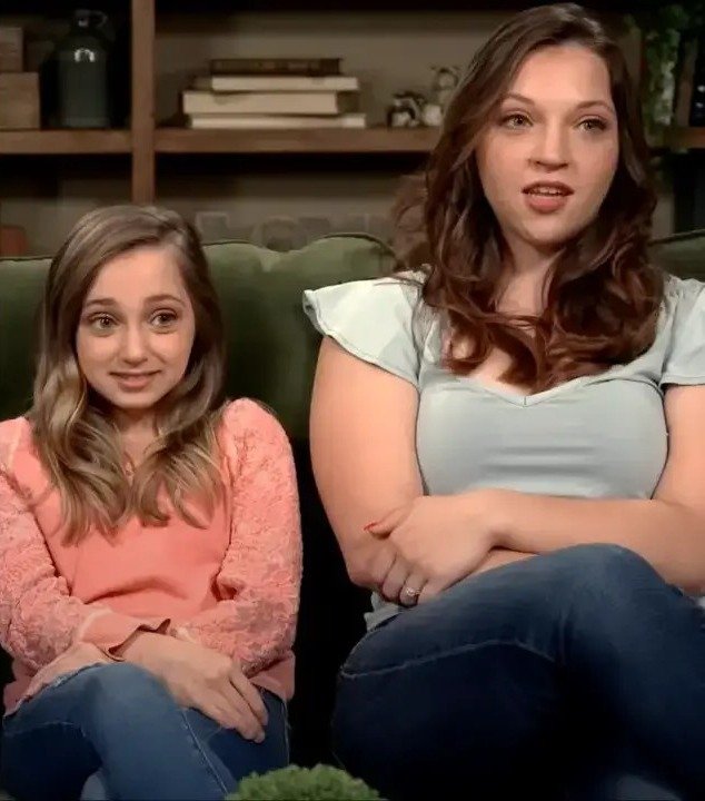 Shauna Rae sitting on a sofa with her sister