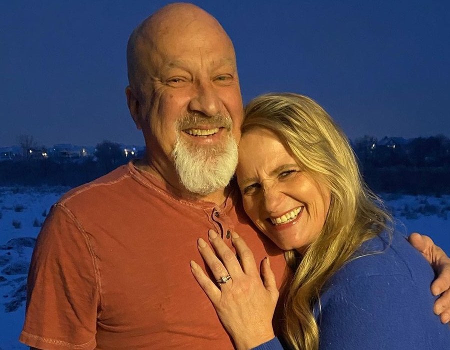 Christine Brown Woolley and David Woolley smiling together outdoors