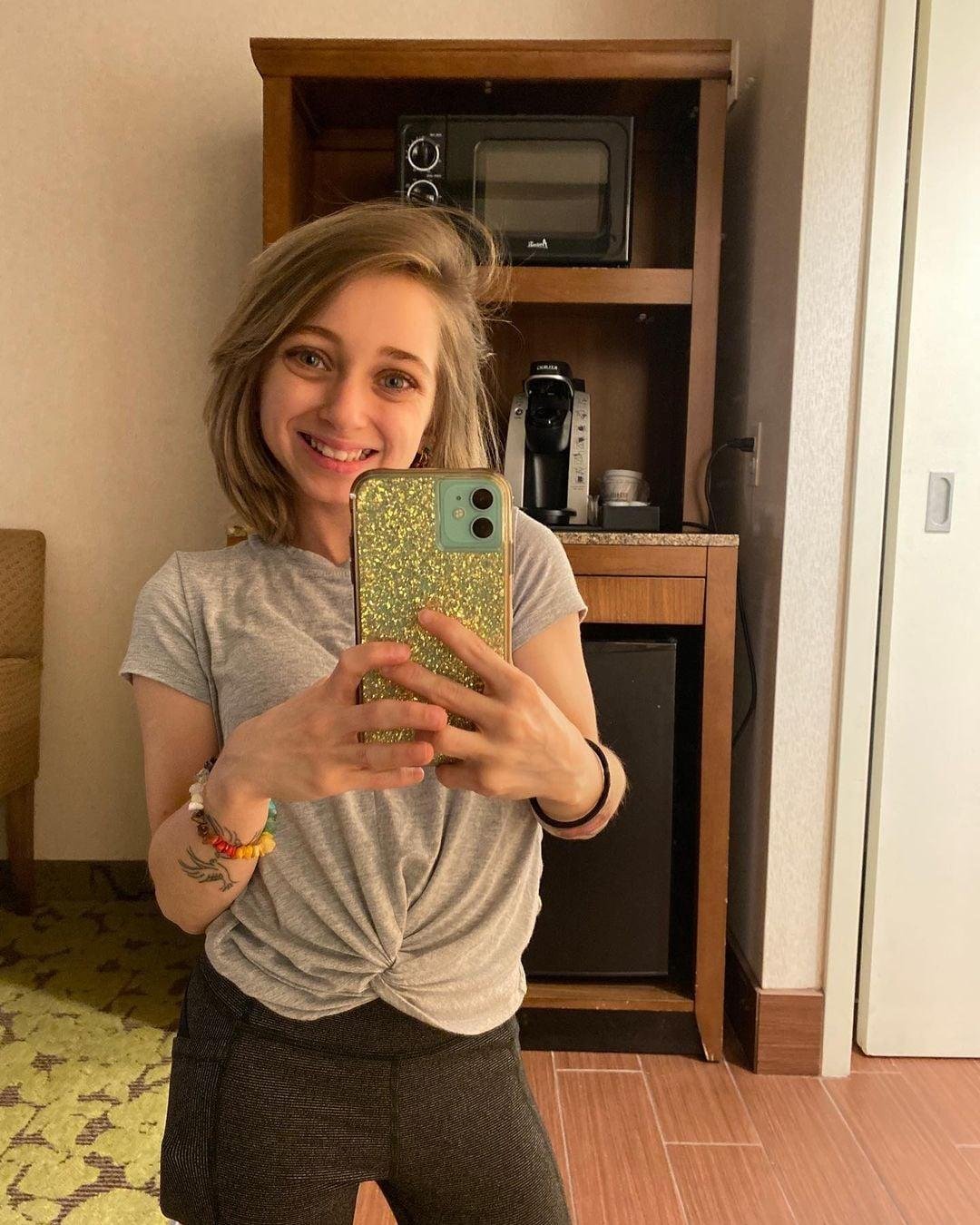 Shauna Rae taking a mirror selfie with a glitter phone case