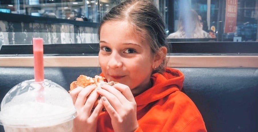 Blayke Busby as a young girl eating at a restaurant