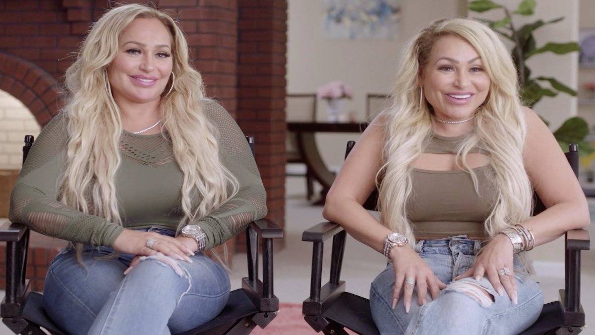 Darcey and Stacey Silva sitting side by side in director's chairs