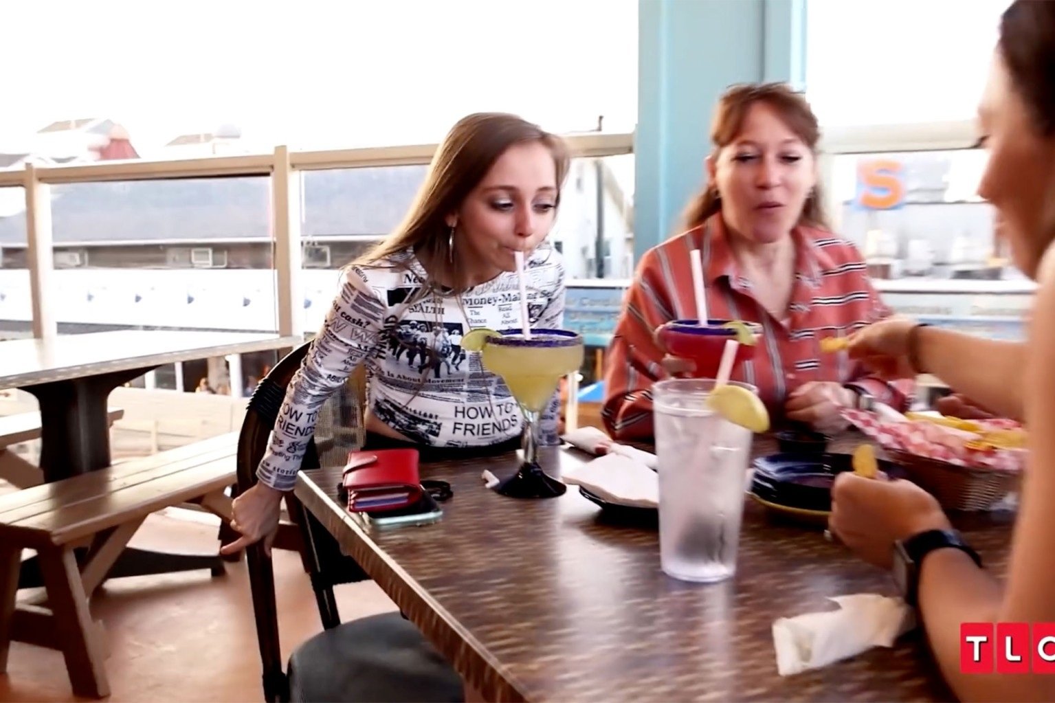 Shauna Rae and her mother Patty Schrankel sitting together at a restaurant table