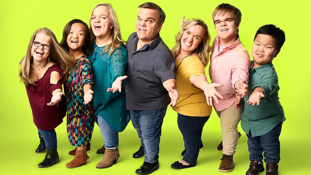 The Johnston family promo photo with green background